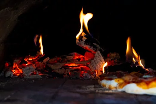 coal oven flames cooking pizza